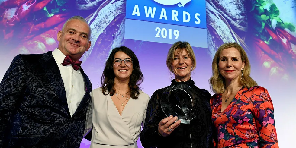 JCS Fish's Louise Coulbeck and Rosie Knight (center-left and center-right) pick up the award from guest host Sally Phillips and awards judge, Steve Lee.