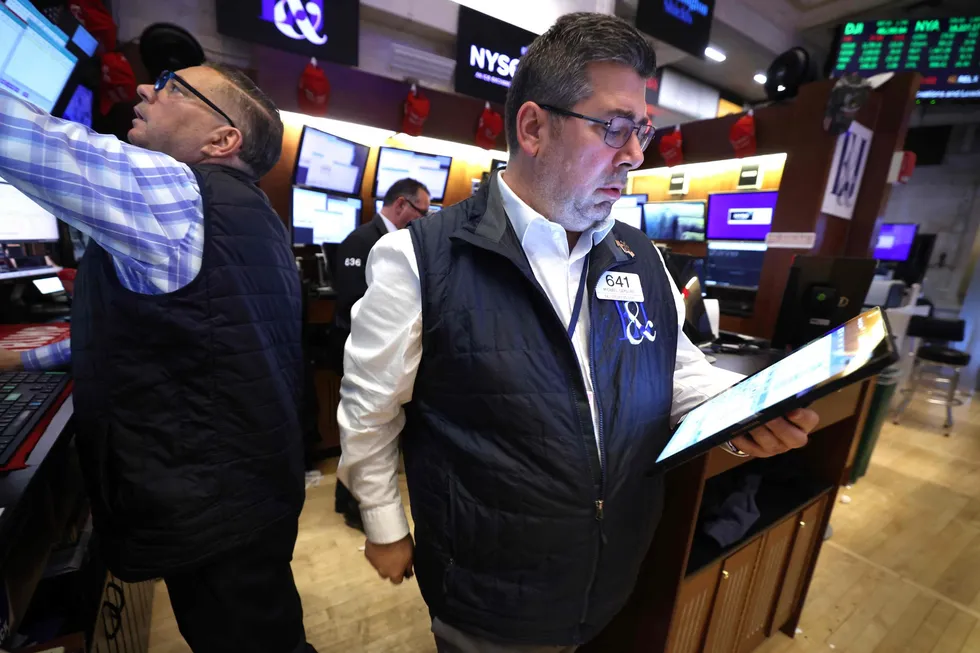 Traders work on the floor of the New York Stock Exchange (NYSE) at the closing bell in New York City, on Friday, 11 April 2025.