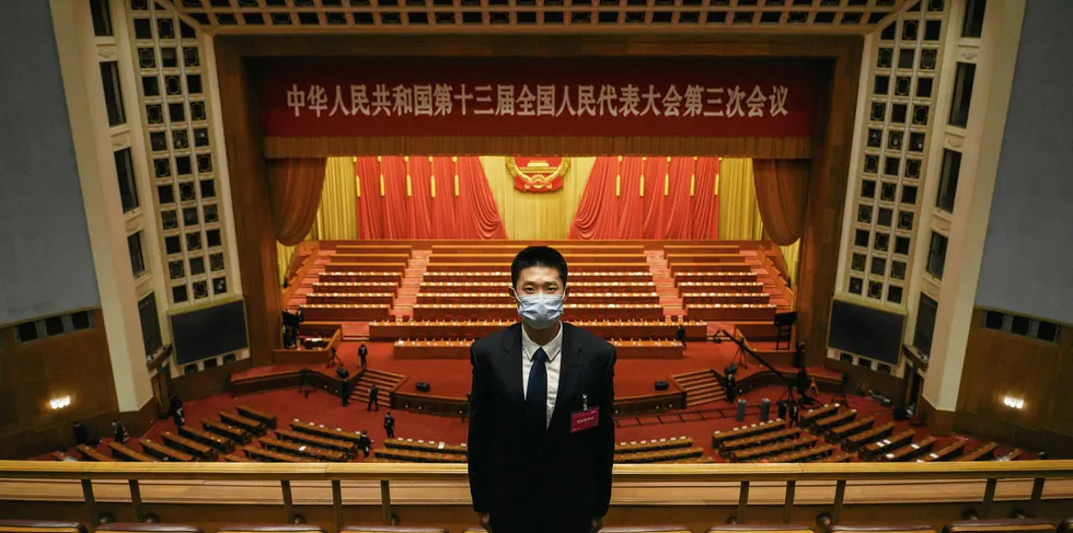 A Chinese security officer wears a protective mask as he guards after the closing session of the National People's Congress at the Great Hall of the People on May 28, 2020 in Beijing, China.