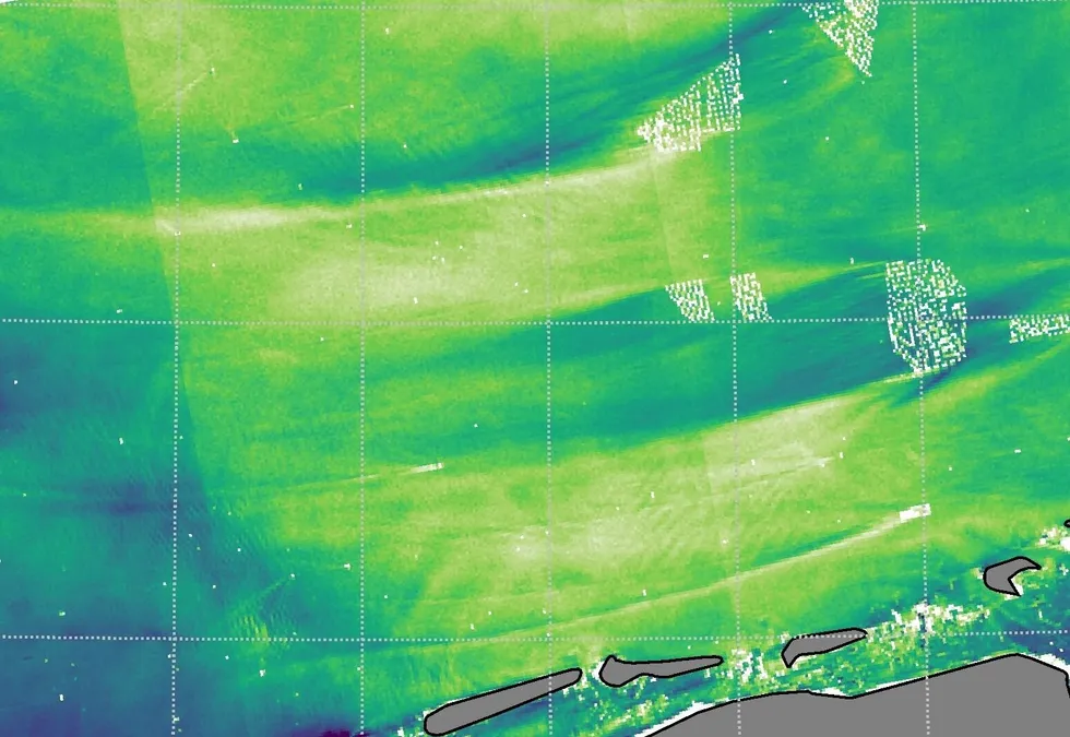 Modelling of wind wakes, long trails of lower intensity wind (marked in dark blue) that stretch behind wind farms, in the North Sea.