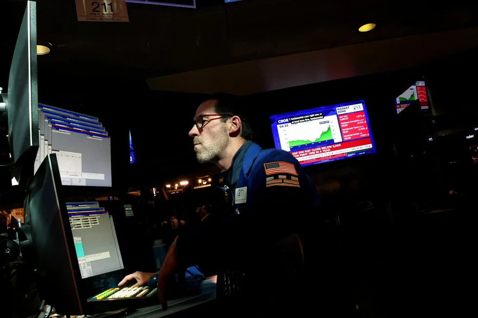 A specialist trader works inside a booth on the floor at the New York Stock Exchange (NYSE) in New York City, U.S., April 8, 2025.