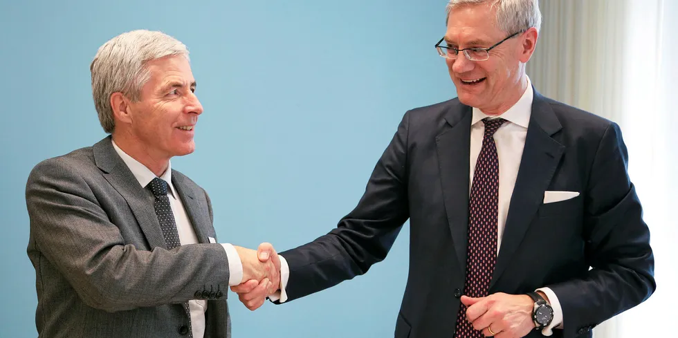 Preem CEO Petter Holland and Vattenfall CEO Magnus Hall shake hands on a green-hydrogen project