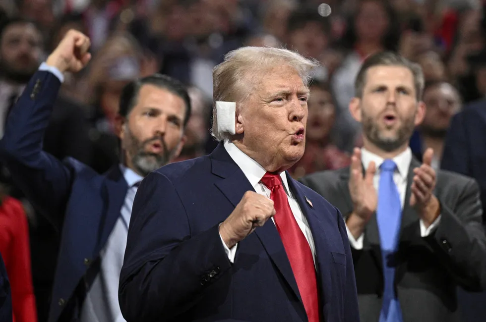 Donald Trump with his ear bandaged after being shot gestures during the first day of the 2024 Republican National Convention on July 15, 2024.