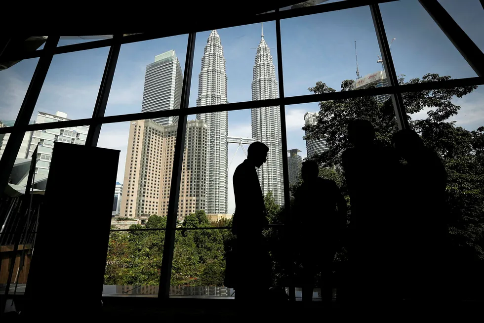 Reflections: Petronas Twin Towers viewed through a neighbouring office in Kula Lumpur