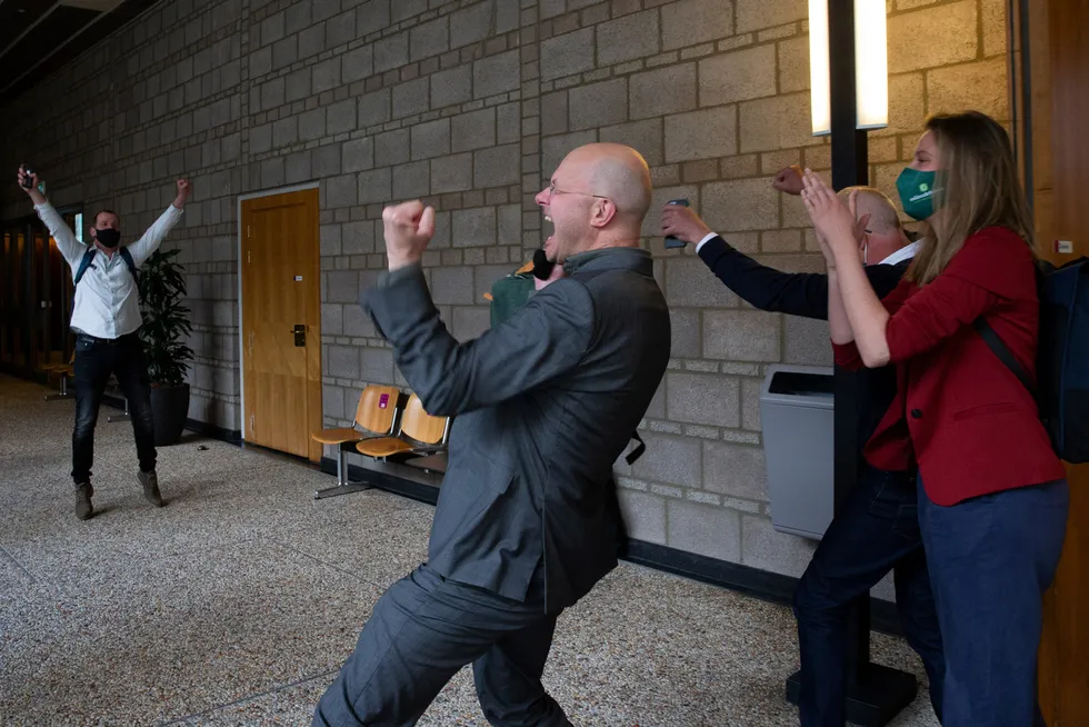 Goal: Milieudefensie director Donald Pols, centre celebrates the verdict in a court case brought by the Dutch arm of Friends of the Earth