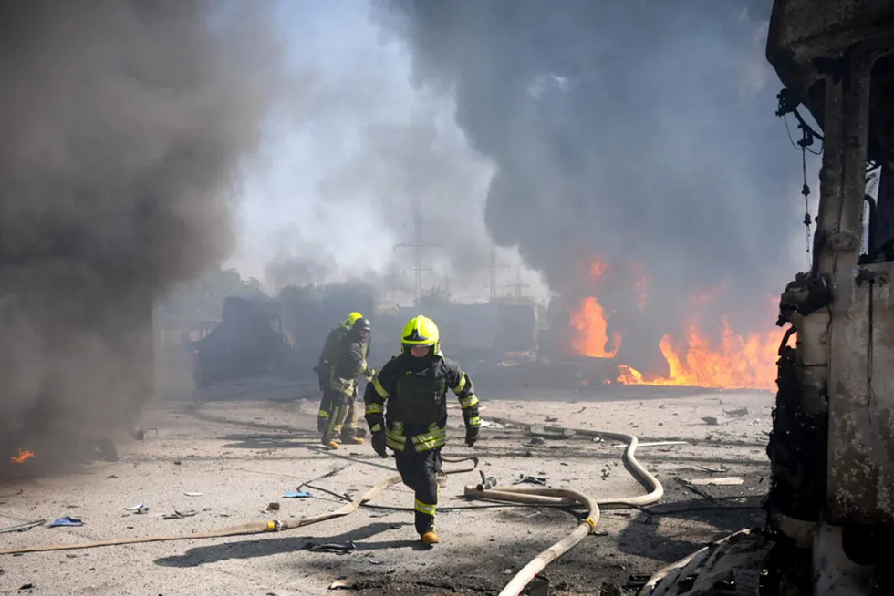 Rescuers work to extinguish a fire following a missile attack at an undisclosed location in Ukraine’s Odesa region following a large scale air attack by Russian forces on 26 August.