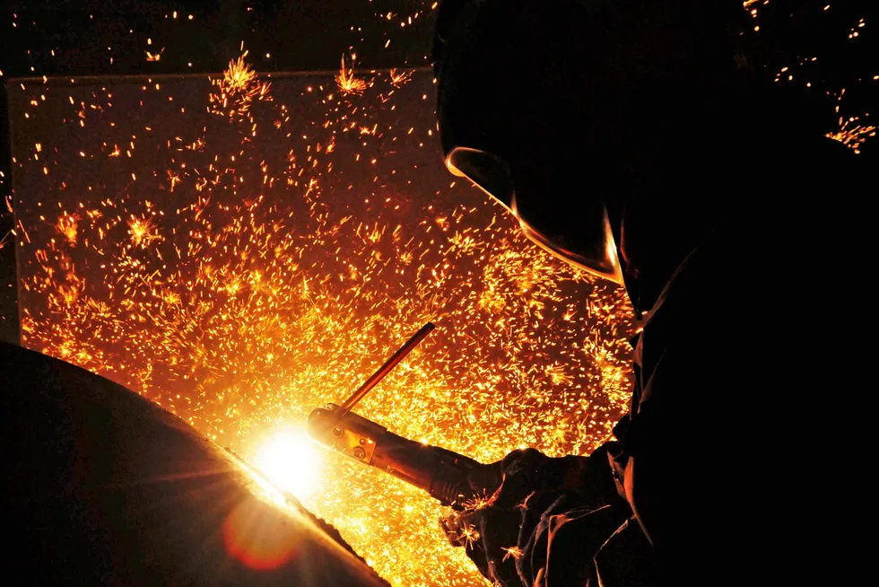 A welder works at a COOEC subsidiary facility in China in this file photo from 2016.