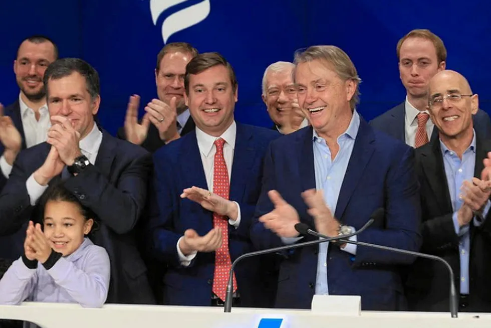 New Fortress Energy chief executive Wes Edens (centre).