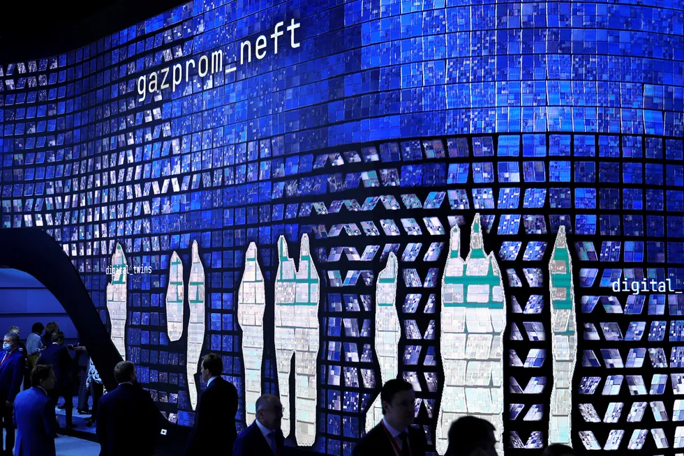 Blue trend: images of passing delegates at St Petersburg International Economic Forum in Russia are projected onto a Gazprom Neft stand