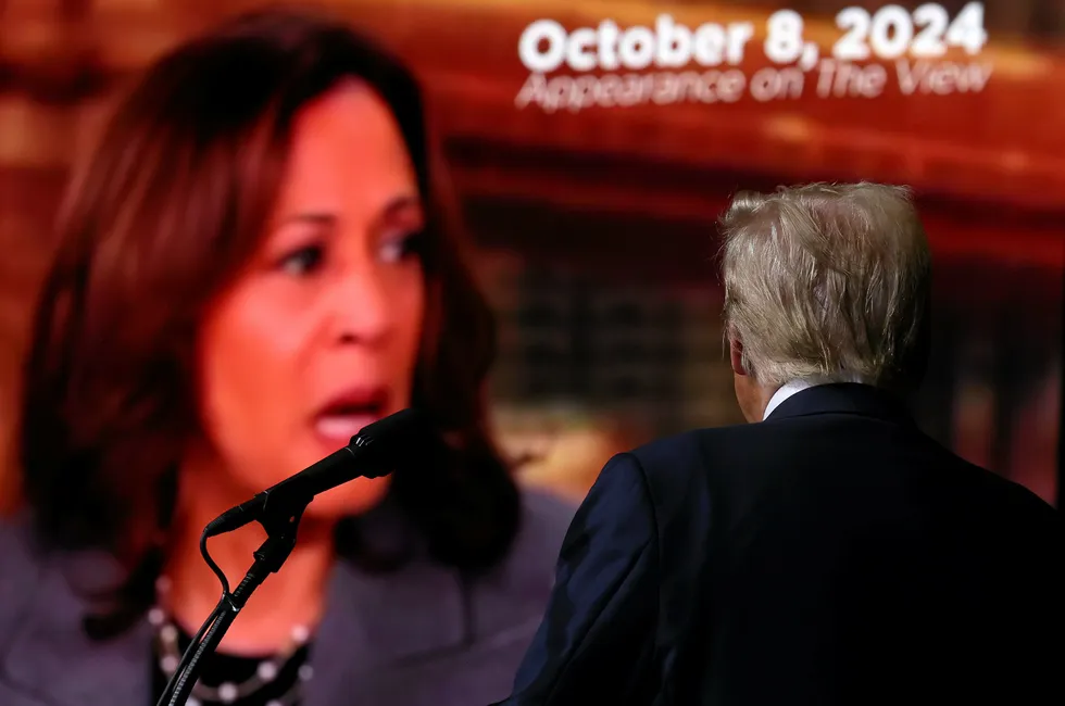 Republican presidential nominee, former U.S. President Donald Trump, watches a video featuring US Vice President Kamala Harris during a campaign rally.