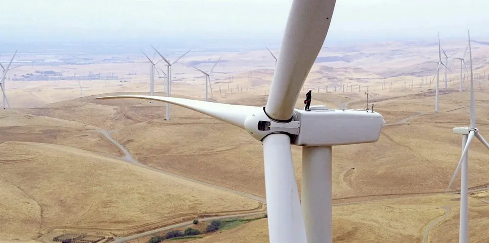An engineer on top of a turbine at a NextEra Energy wind farm.