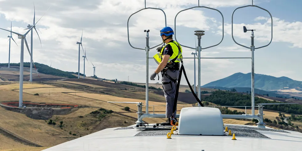 Technician servicing wind farm with Nordex turbines
