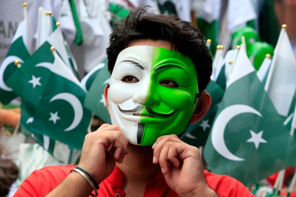 A boy wears a mask with the colours of the national flag in Peshawar, ahead of the 78th Pakistan Independence Day celebrations.