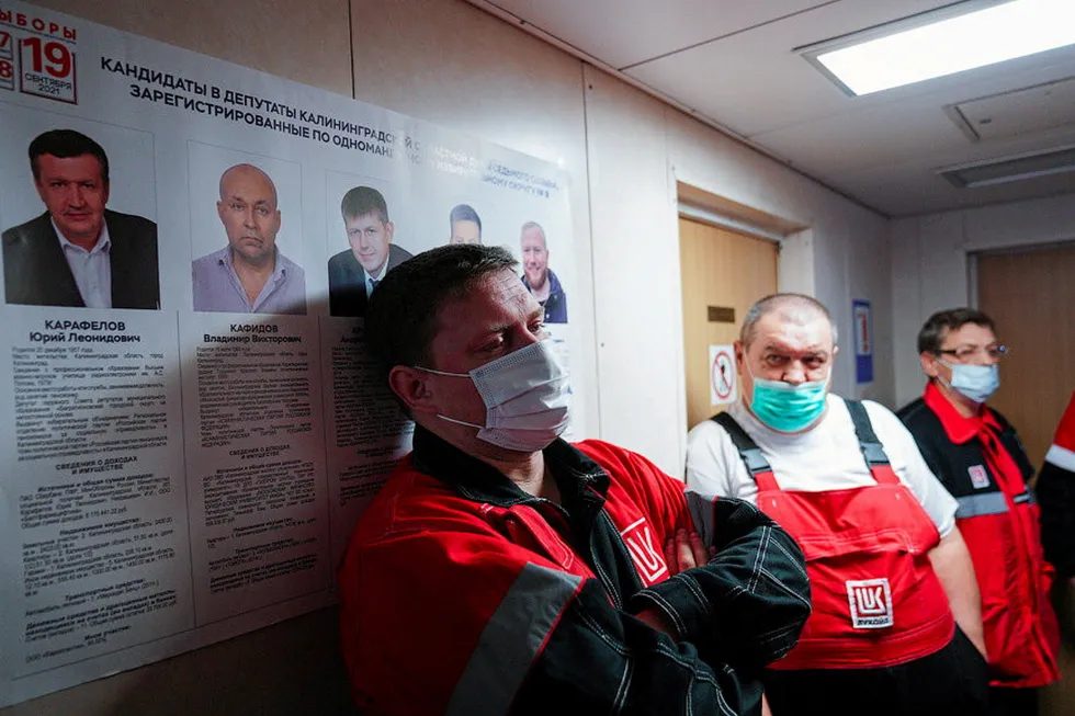 Show goes on: workers queuing to cast their parliamentary votes on the Lukoil-operated offshore oil production platform D-6 in the Baltic Sea