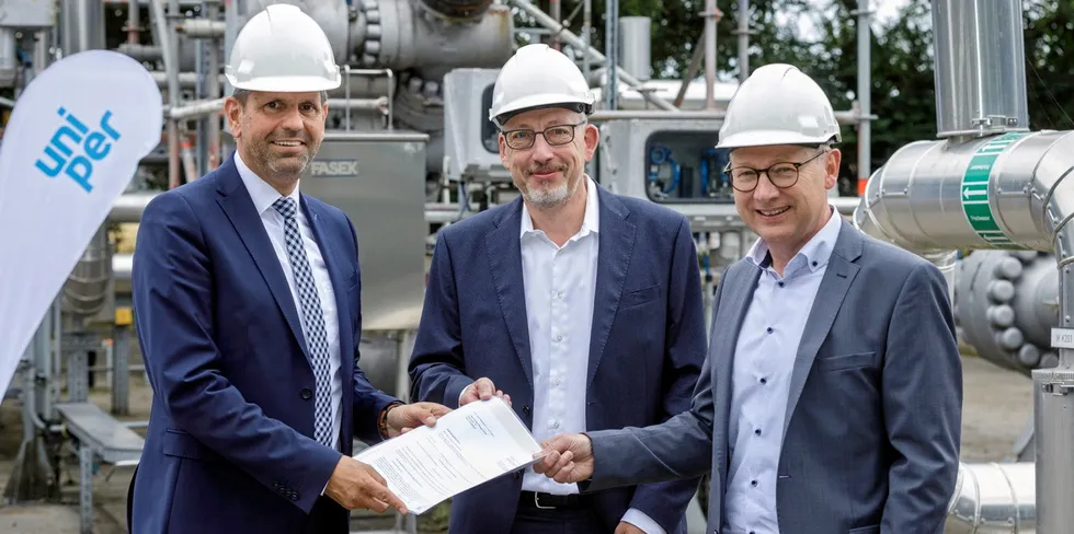 Lower Saxony environment minister Olaf Lies, left, hands notification of the grant to Uniper Energy Storage vice-president for operational performance, Frank Holschumacher, centre, and head of Asset Group North, Johann Westerbuhr.