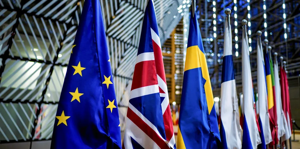 A picture taken on January 29, 2020 shows the European Union flag and the British Union Jack on display at the Europa building in Brussels.