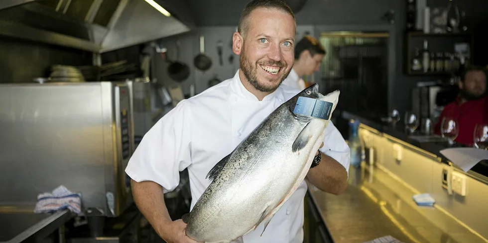 A New York chef holds an Ora King salmon.
