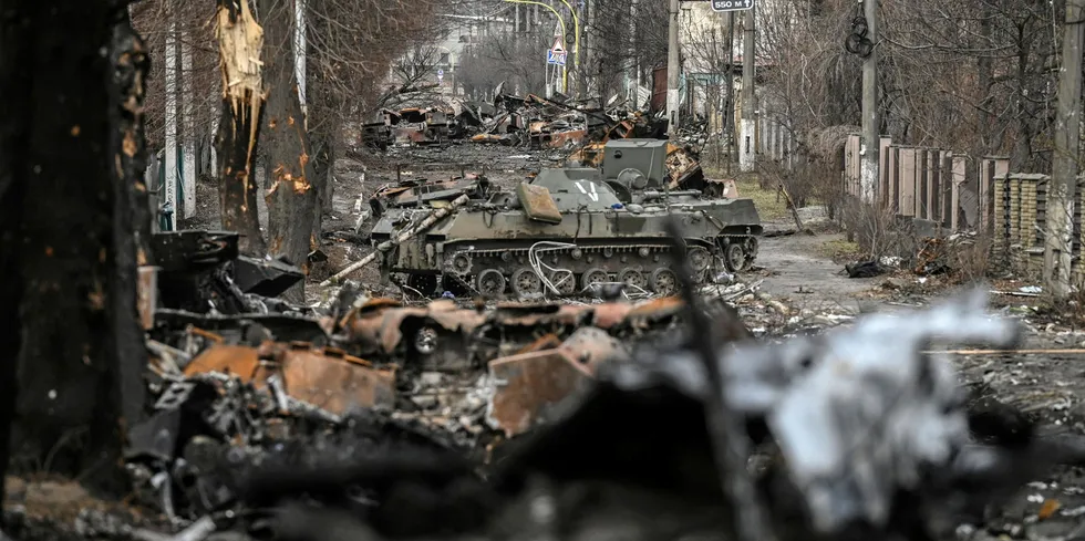 Destroyed Russian armored vehicles line the street in the city of Bucha.