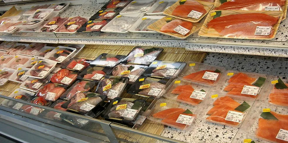 Fresh fish on display in a Japanese supermarket counter.
