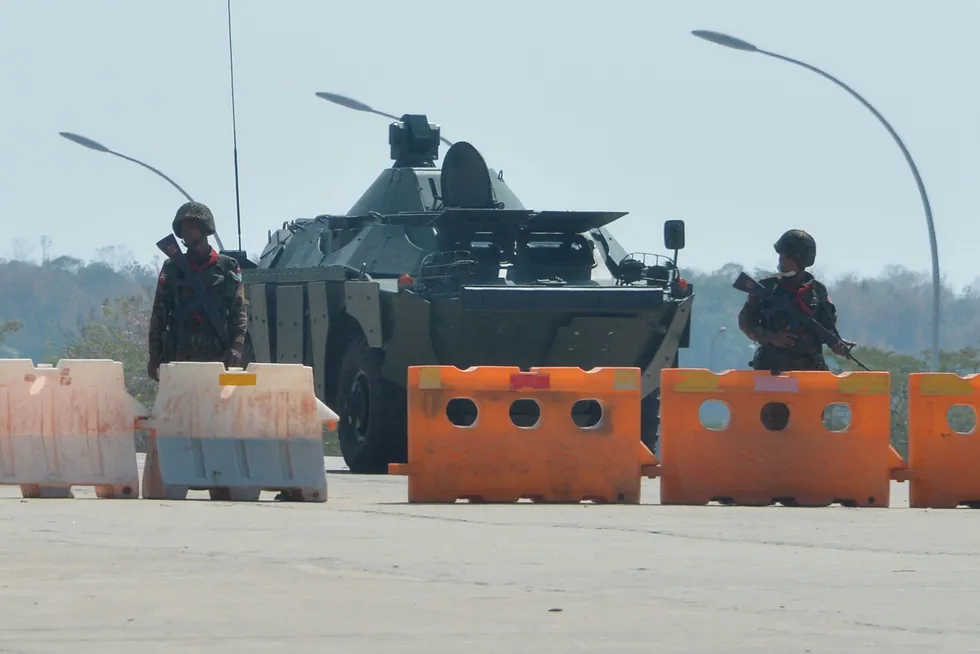 Military coup: soldiers stand guard on a blockaded road to Myanmar's parliament in Naypyidaw on 1 February
