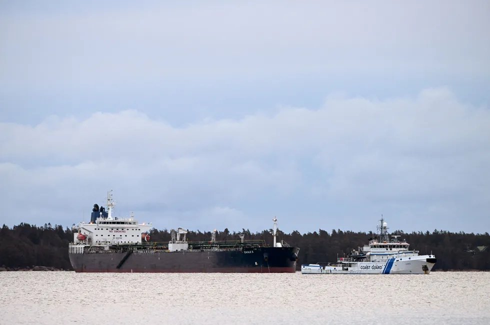 A Finnish Coast Guard vessel keeps watch on the Eagle S oil tanker, anchored near Kilpilahti port in Porvoo, on Monday.