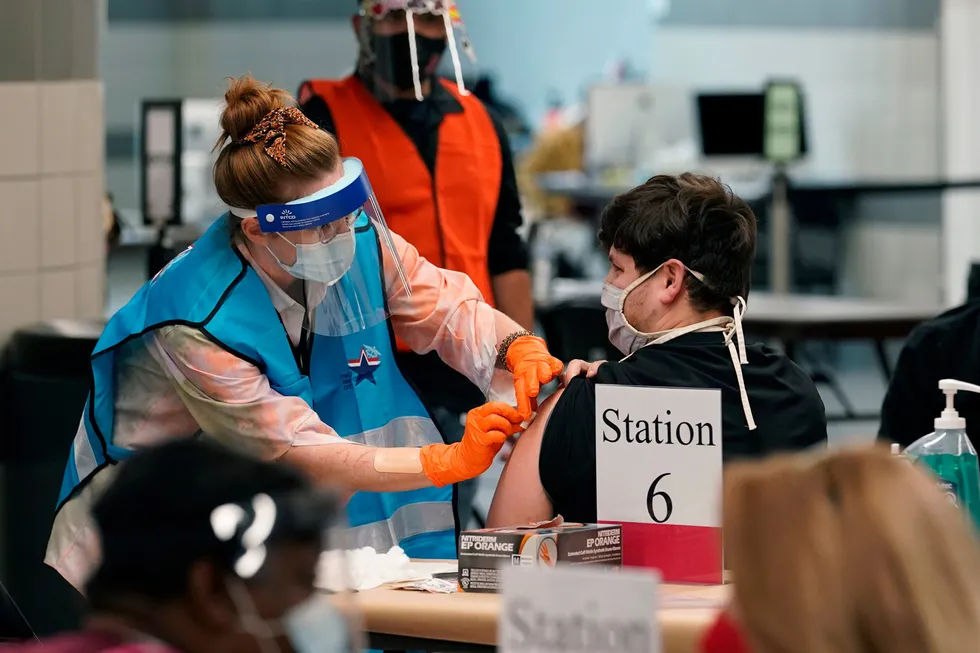 OUNCE OF PREVENTION: A health care worker administers a Covid-19 vaccination in Texas.
