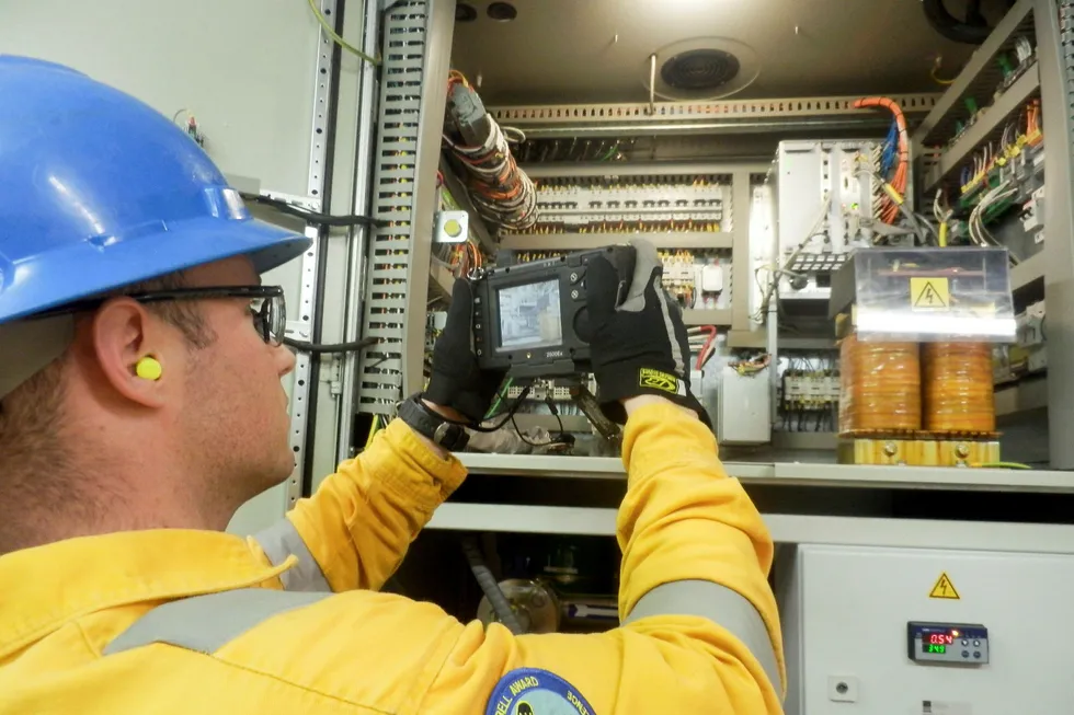 CLOSE-UP: Michael Guillory, electrician onboard the ultra-deepwater drillship Noble Don Taylor, uses the Onsight camera to help the RTTSC support staff troubleshoot a fault in an electrical cabinet.