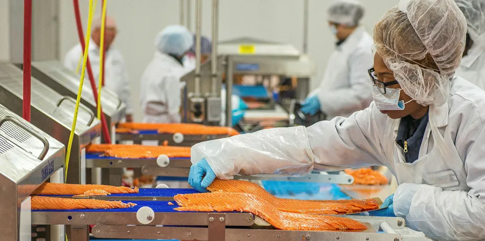 A worker at Acme Smoked Fish, one of the largest recipients of the US Payroll Protection Program (PPP) loans.