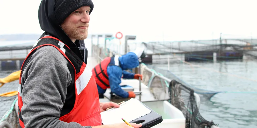 A worker at a Cooke Aquaculture farming site on Hope Island in Washington State.