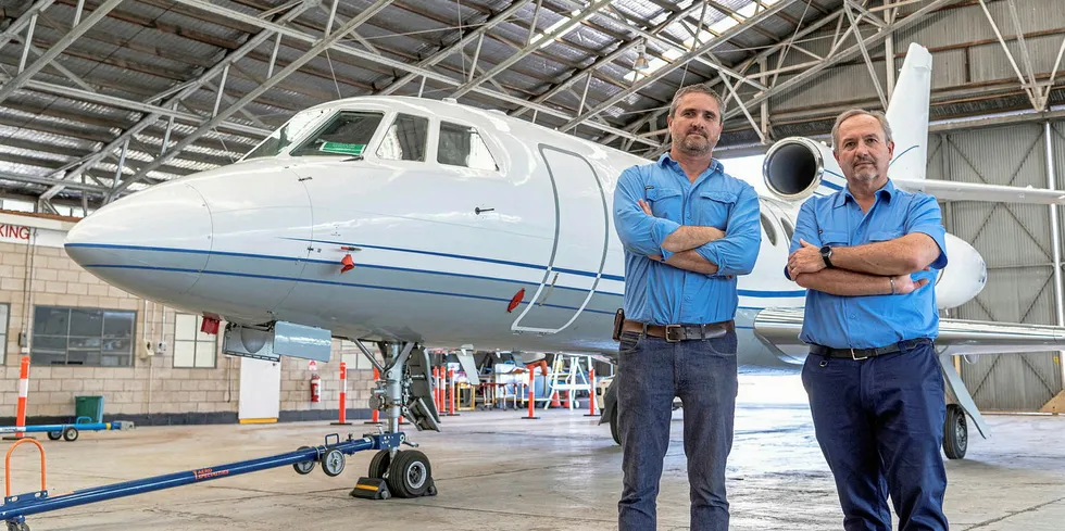 Helmut Mayer (right) and his brother Christof, who are both directors of Aviation H2, in front of the Falcon 50 private jet they want to convert to run on liquid ammonia.