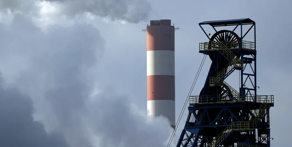 Chimney of Laziska Power Station, a thermal power plant, is seen behind Boleslaw Smialy Coal Mine in Laziska Gorne, Poland