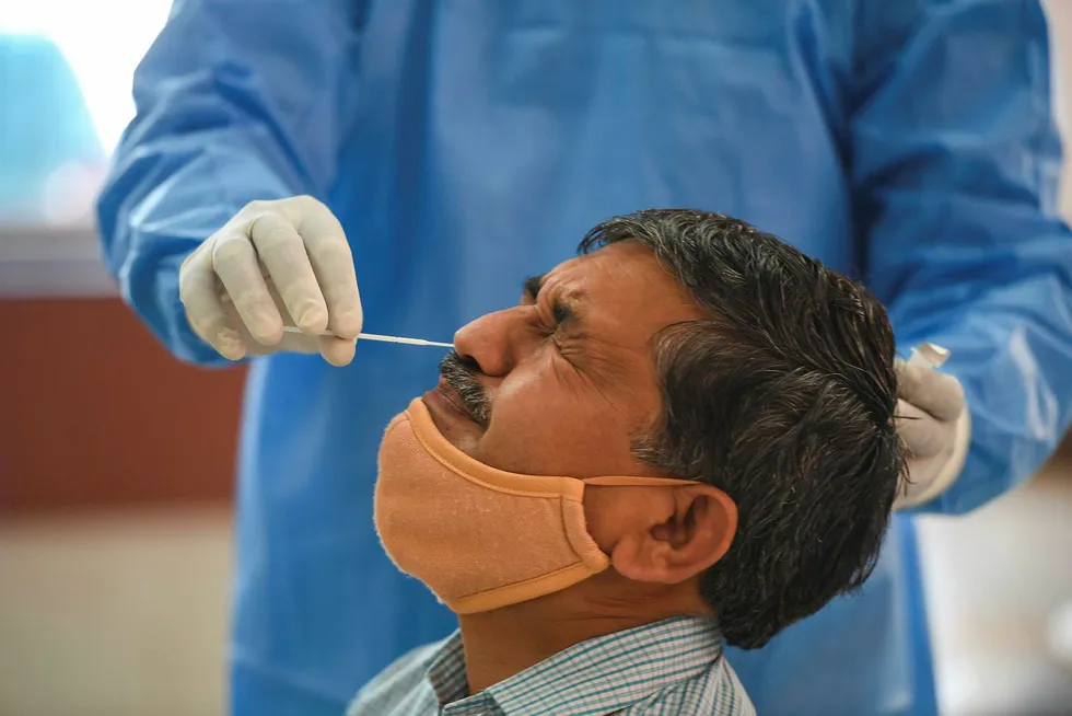 Invasive: a swab sample being taken for a Rapid Antigen Test for the coronavirus