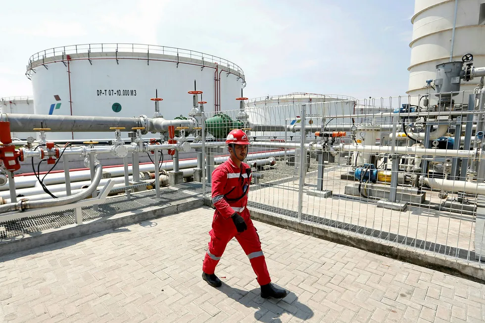 New assets: a worker at a Pertamina facility in Indonesia. The state company is planning a new pipeline in Sumatra