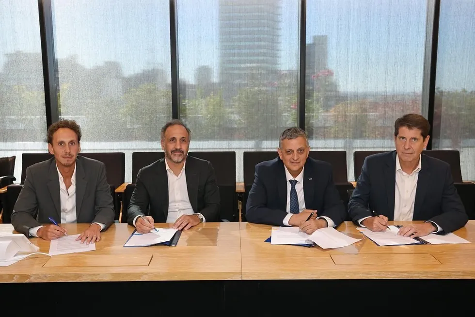 Pan American Energy Group chief executive Marcos Bulgheroni (centre left) and YPF chief executive Horacio Marin (centre right) sign up to work together with Southern Energy’s partners.