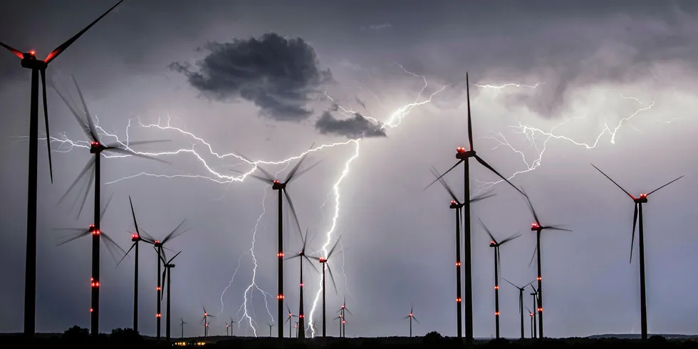 Lightnings flash over windmills at Eastern German wind farm