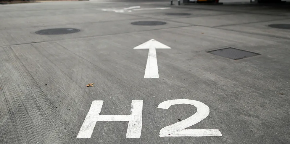 An H2 sign, painted on the forecourt, directs vehicles towards Royal Dutch Shell Plc's hydrogen refueling pumps at their first UK hydrogen refueling station fuel station.