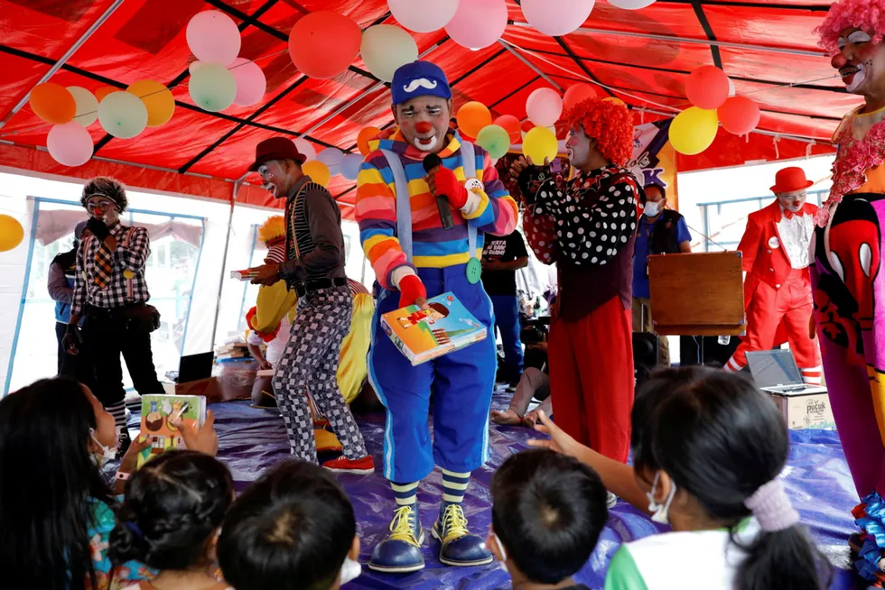 Smiles all round: Dedy Rachmanto, founder of an Indonesia clowns' association, performing to children in East Java province, Indonesia