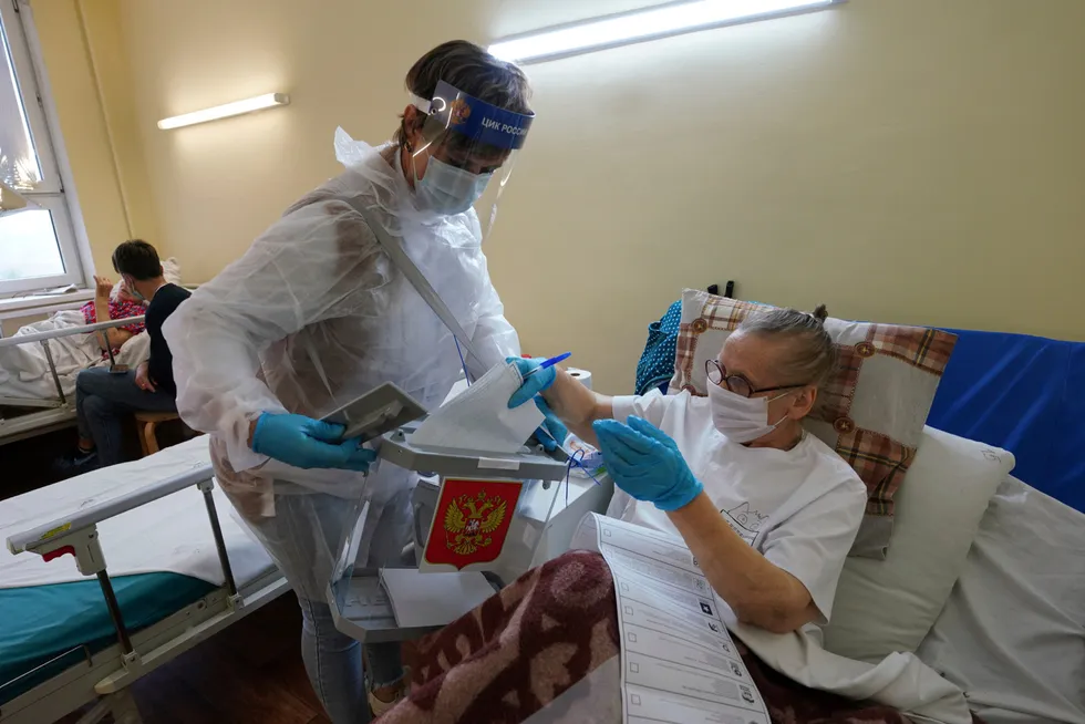Ailing: a medical worker helps a patient to cast her ballot at a hospital during the parliamentary election campaign in the city of Voronezh, amid fears that democracy is weakening in Russia