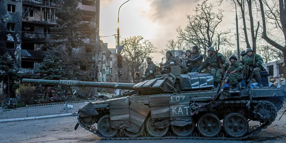 A tank by pro-Russian DPR forces in a burning Mariupol neighborhood