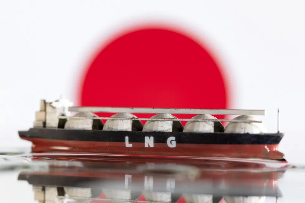 FILE PHOTO: Model of LNG tanker is seen in front of Japan's flag in this illustration taken May 19, 2022. REUTERS/Dado Ruvic/Illustration/File Photo