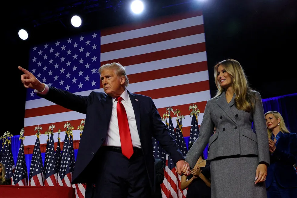 Republican presidential nominee and former president Donald Trump gestures as he holds hands with his wife Melania during a rally West Palm Beach, Florida on Wednesday.