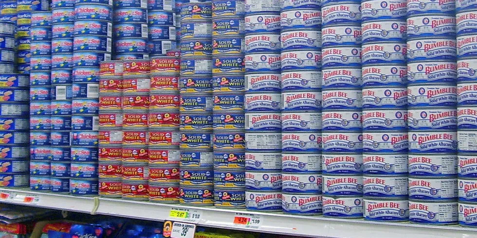 A supermarket shelf of canned tuna.