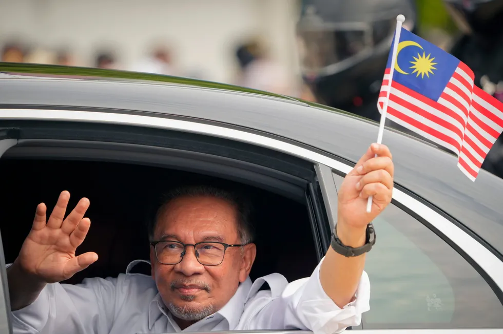 Malaysian prime minister Anwar Ibrahim waves the national flag on 31 August 2024