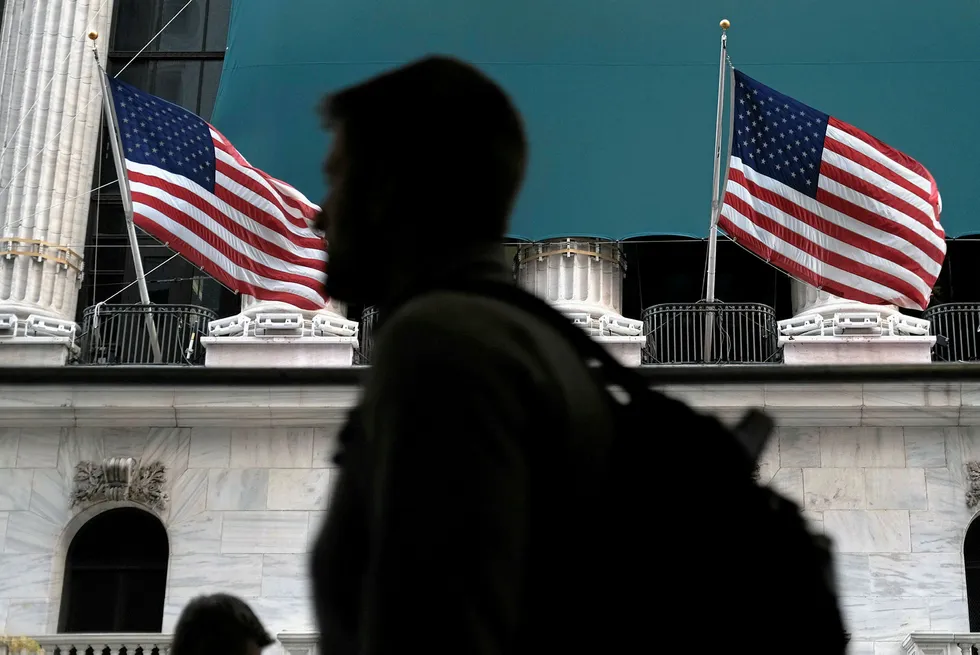 Sharing the view: people walk by the New York Stock Exchange