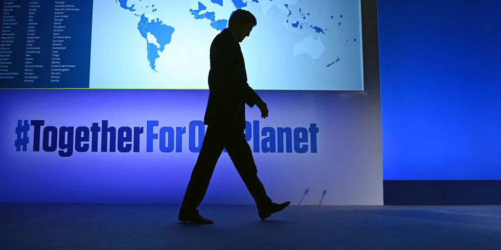 US Special Presidential Envoy for Climate John Kerry arrives on stage to deliver a speech during COP26.