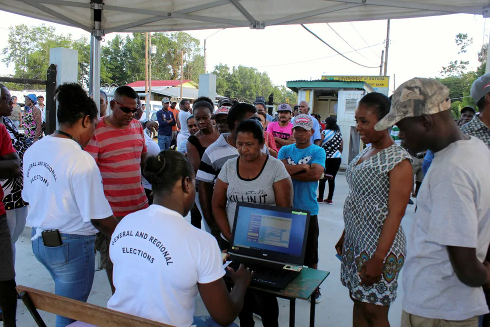 Patience: voters wait their turn in Guyana's presidential elections, held March 2, but accusations of irregularities in mean a full recount is likely