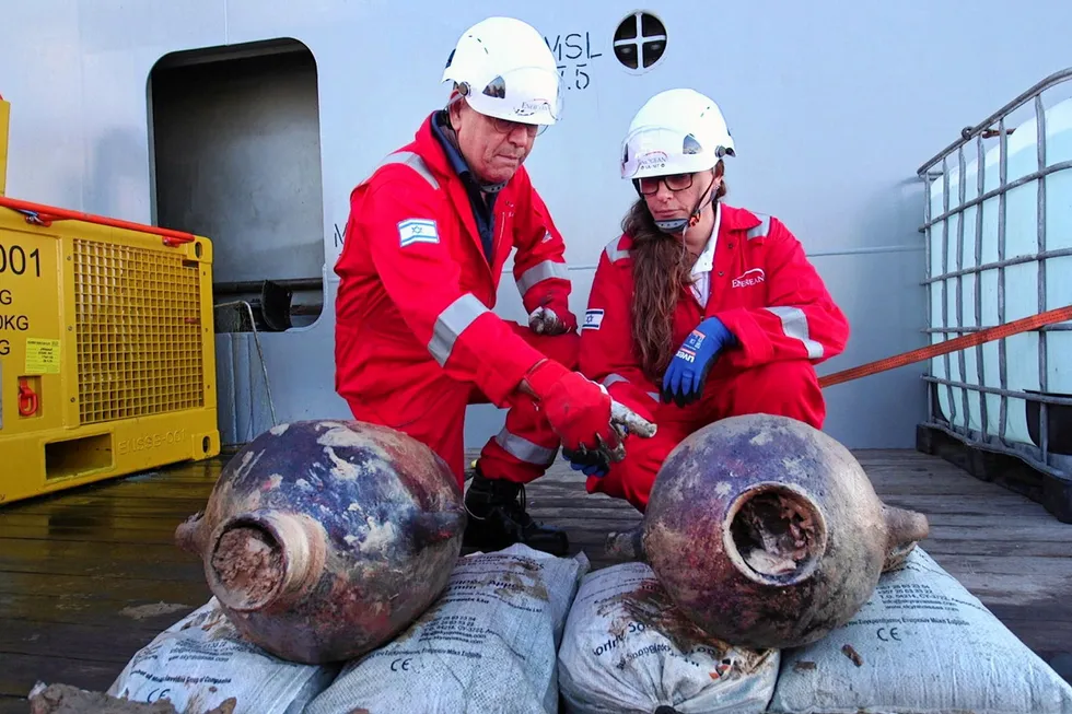 Jacob Sharvit, Israel Antiquities Authority's marine unit (left), with Dr Karnit Bahartan, environmental lead at Energean, study the recovered ancient amphorae.