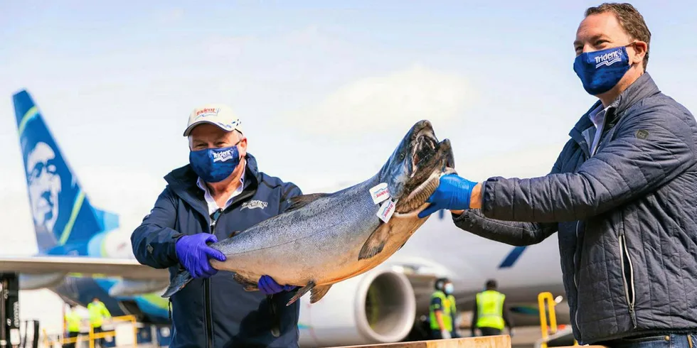 From left to right: Vic Scheibert who manages operations for Trident Seafoods in Alaska and Trident CEO Joe Bundrant hold up the first Copper River salmon to arrive in Seattle this year.