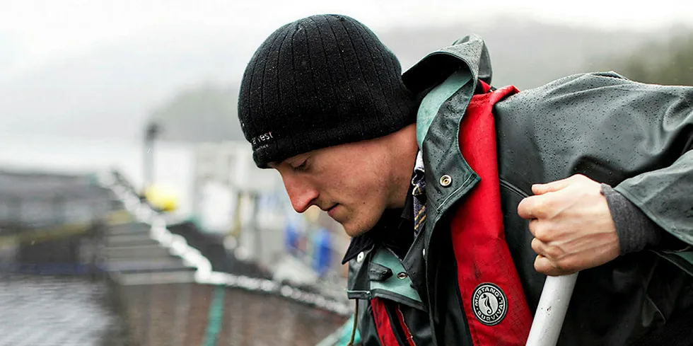 BC salmon farm worker on a net pen.