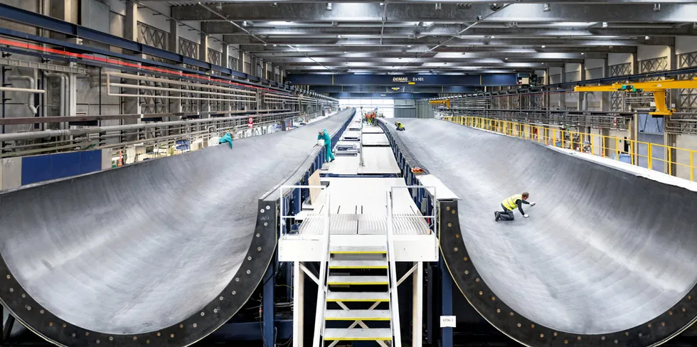 Vestas employees perform checks on 15MW V236 wind turbine blade mould at factory in Nakskov, Denmark